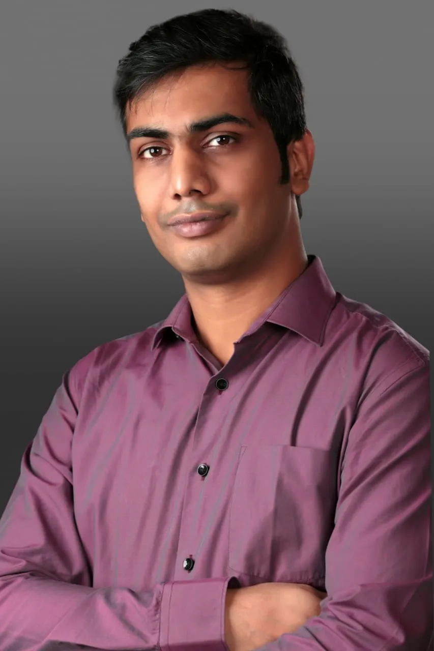 Abhishek Goyal, arms crossed, smiling at the camera